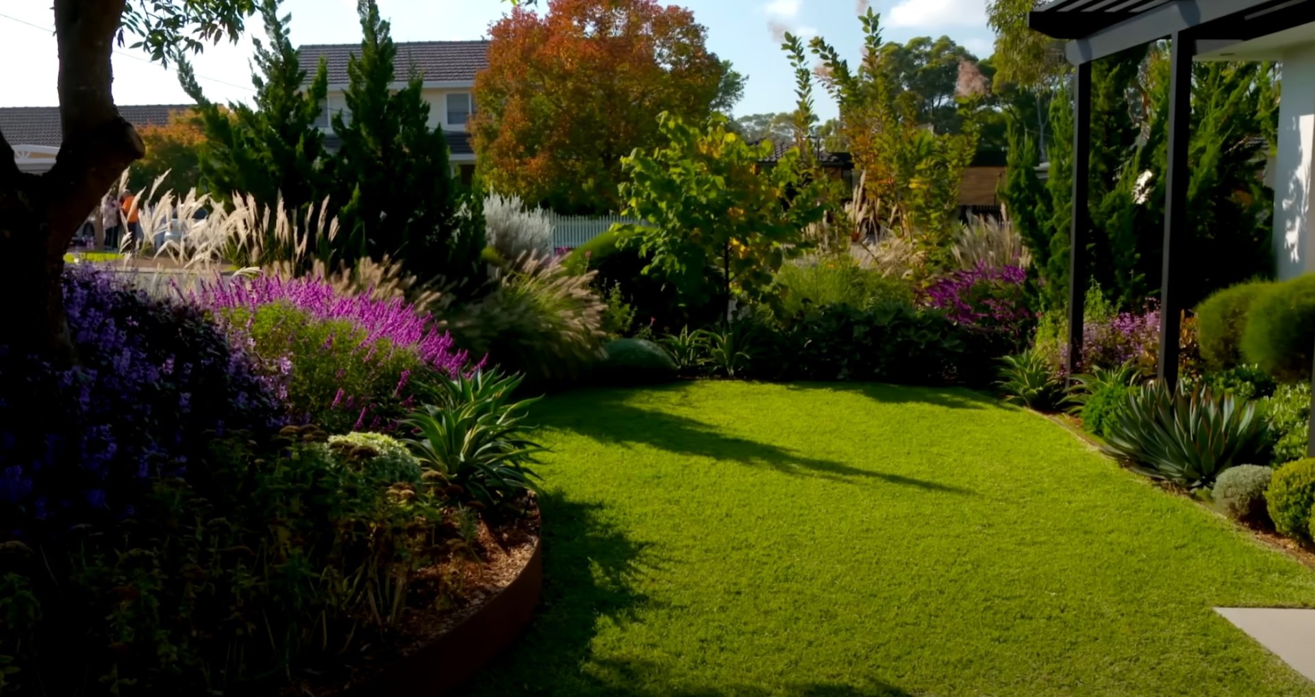 Professional landscaping design featuring native plants and seasonal flowers Beautiful landscaped garden with lush green lawn and colorful flower beds in Mission Viejo