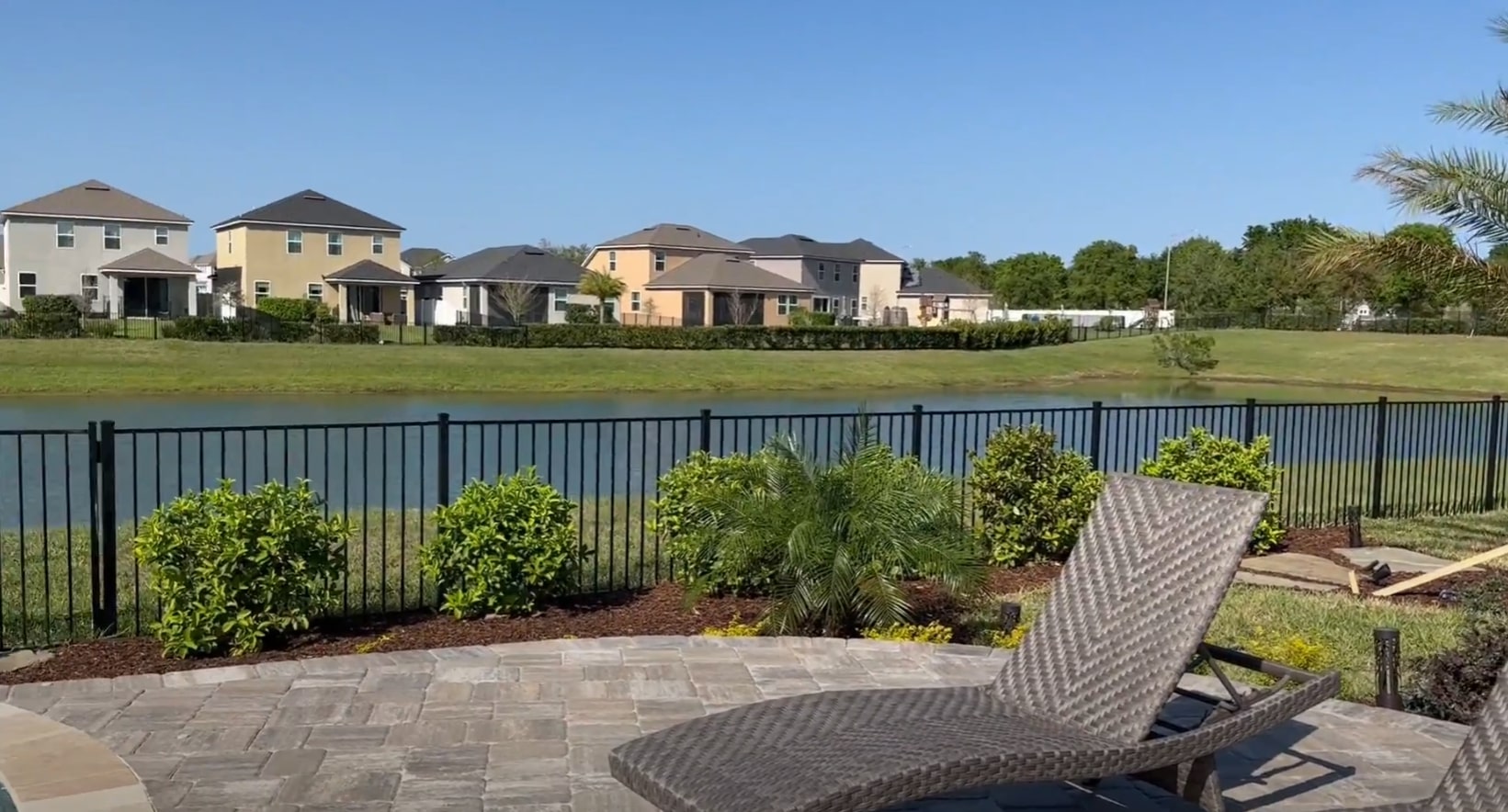 Custom hardscaping design featuring natural stone patio and professional landscaping Beautiful stone patio with outdoor furniture surrounded by lush landscaping